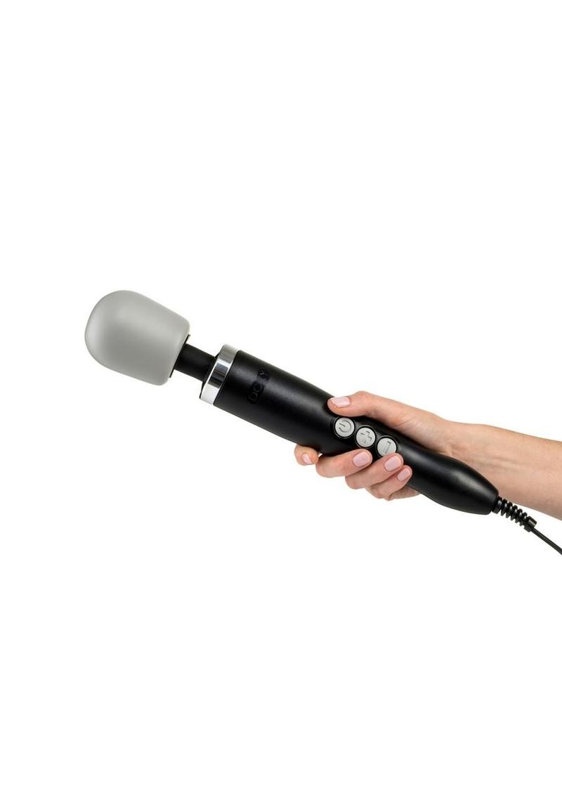 Hand holding black wand with gray domed head and three gray buttons with black cord. The unparalleled power makes this one of the best sex toys available.
