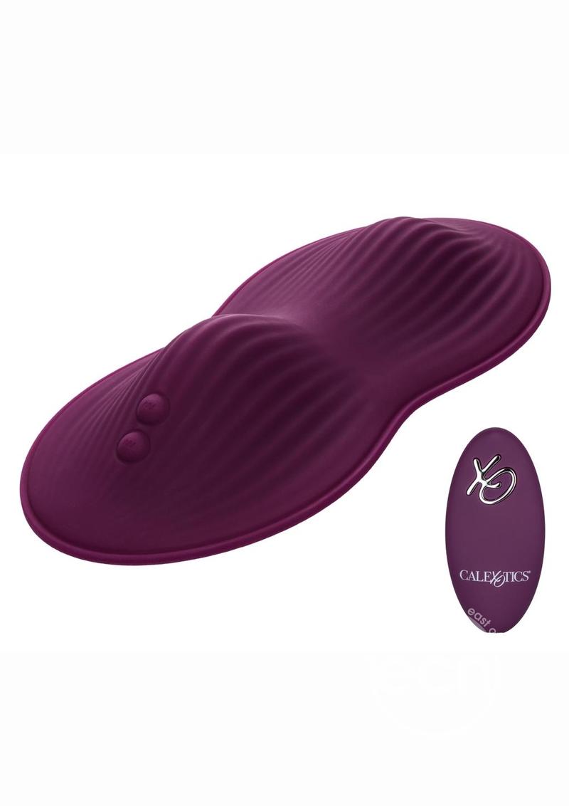 A burgundy saddle-like pad with two humps for grinding. Each mound is ribbed for pleasure.Two small buttons on one end. Small burgundy remote to match. Love yourself with this amazing sex toy.