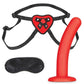Black adjustable straps with heart-shaped piece at the front that secures a small red silicone dildo. Black blindfold included.