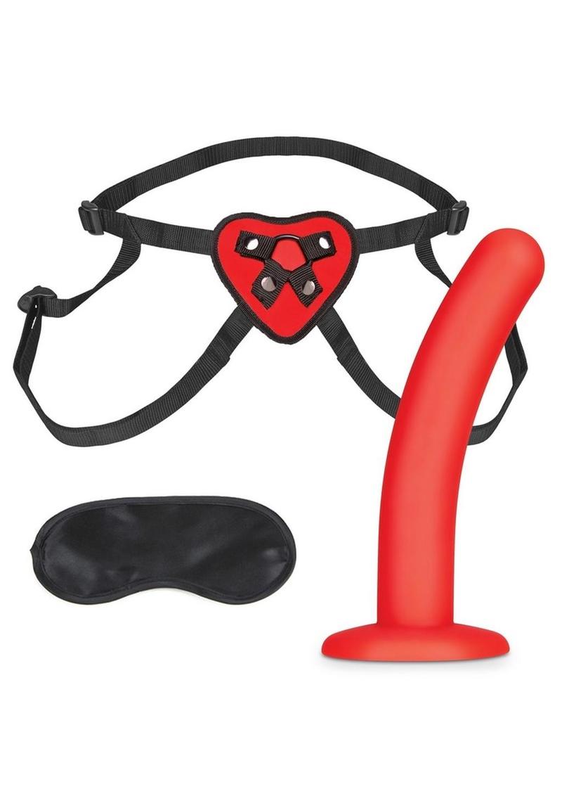 Black adjustable straps with heart-shaped piece at the front that secures a small red silicone dildo. Black blindfold included.