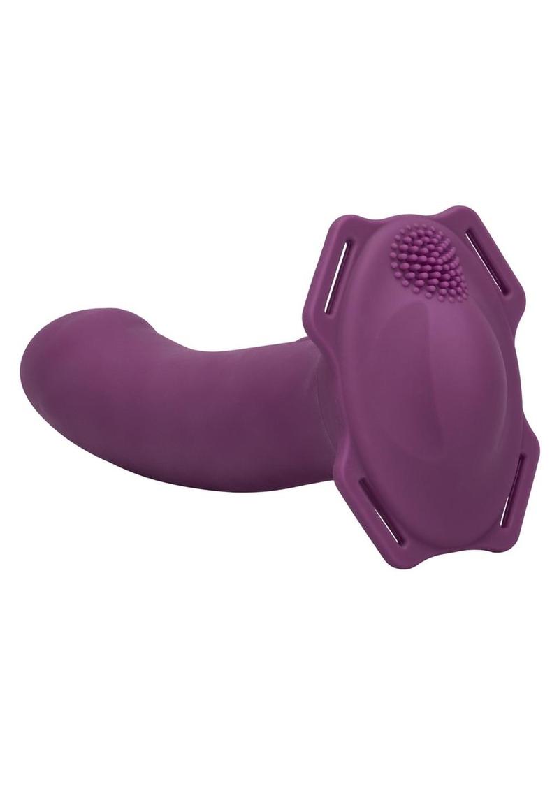 Purple dildo with 4 holes for straps and textured top for wearer.