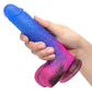 Hand holding Blue to Pink ombre glitter finish dong with balls and suction cup base. Life-like shaft texture and realistic tip head.