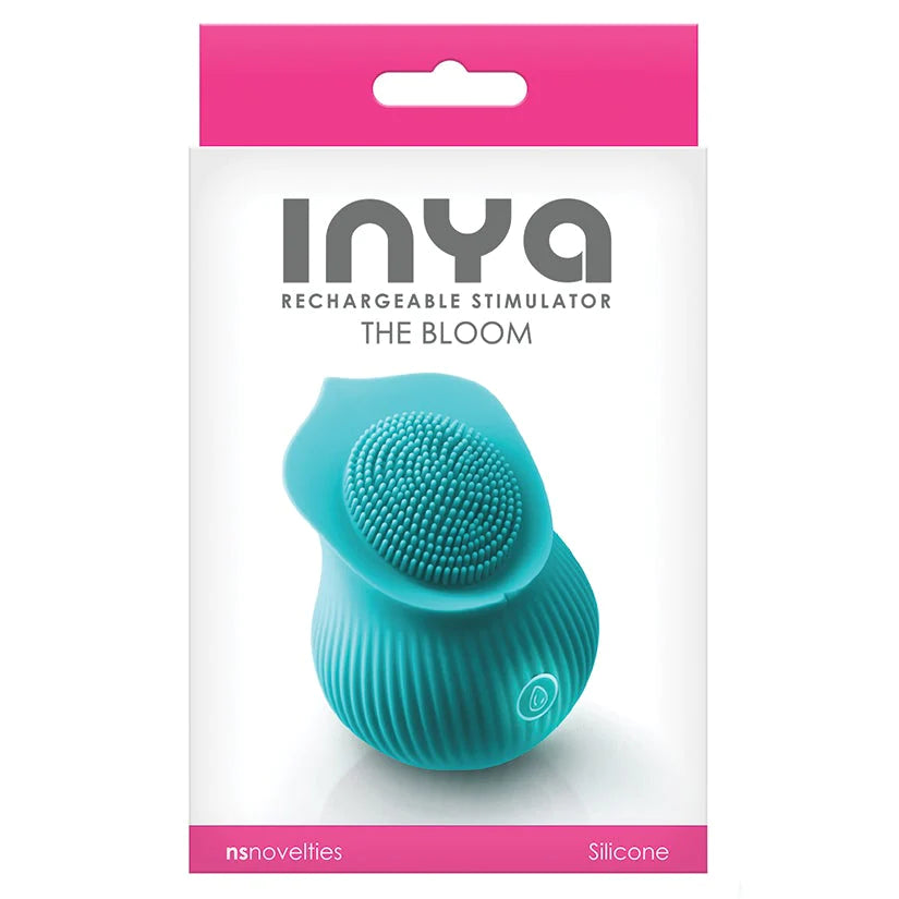 Teal rose shaped vibrator with tiny finger like texture in the center for clitoral stimulation. One illuminated power control button on the front. Packaged in pink and white box.