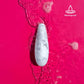 Waterproof white marble clitoral stimulator in water.