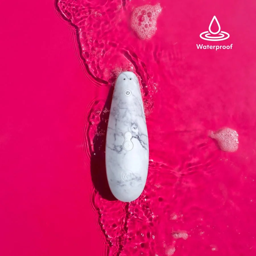 Waterproof white marble clitoral stimulator in water.