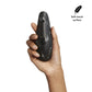 Hand holding black marble clitoral stimulator with 3 buttons on back. Soft-touch surface.