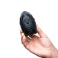 Cylindrical black toy being held in someones hand, great couples sex toy or for self-love.
