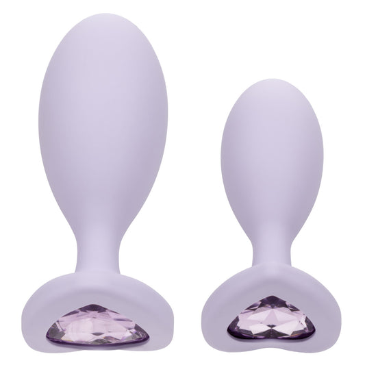 Pale purple egg shaped anal plugs in two sizes with a heart shaped gem at base.