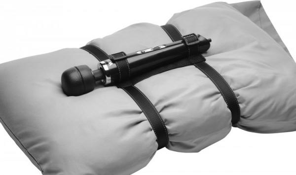 Wand vibrator strapped around a white pillow. Two straps secure around the Wand and two straps secure around the pillow. Love yourself with this self-love sex toy tool.