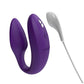Purple u-shaped toy with controls on one side, textured on the inner part of one side for internal stimulation and bulkier opposite side for external stimulation to the clit. White charger with magnetic connection. One of the best sex toys for couples and also amazing for self-love.